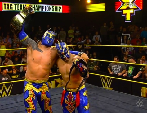 The Lucha Dragons earned the upset win and celebrate with the NXT Tag Team straps.